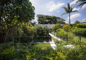A modern residential landscape featuring concrete structures and lush greenery.