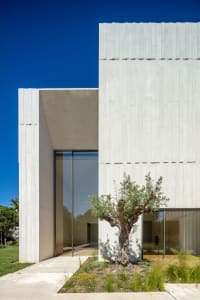 A modern residential building with a concrete exterior