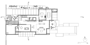 Floor plan of a modern residential interior with open living spaces, kitchen, and outdoor patio.