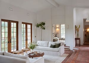 A minimalist living room with natural fibers, concrete, and wooden elements.