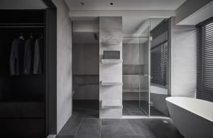 Modern bathroom featuring marble and stone materials with a walk-in shower and freestanding tub.