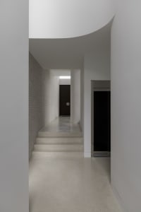 Modern hallway with concrete and brick walls and floors.