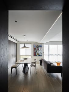 A modern living and dining space featuring hardwood flooring, minimalistic design, and sleek furniture.