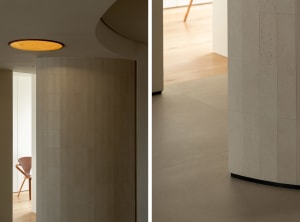 Modern residential interior with tile flooring and concrete elements.