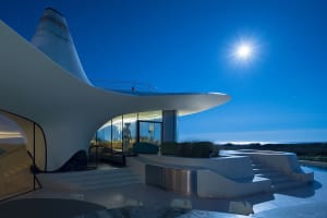 Modern residential exterior featuring extensive use of glass.