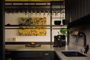 Modern industrial kitchen with concrete countertops, metal accents, and minimalist design.
