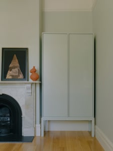 Modern cabinet and fireplace in a living room setting.