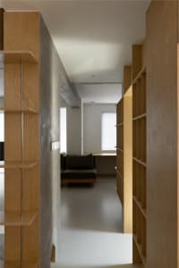 Modern interior design featuring wooden shelves and minimalist furniture.