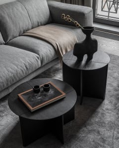 Modern living room featuring black side tables with minimalist design.