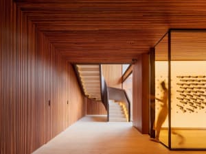 A modern interior design featuring a wooden staircase with a warm, ambient light.