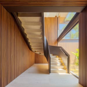 A modern wooden staircase indoors with natural light.