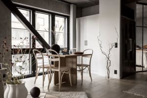 Modern dining room with wooden flooring and minimalist decor.