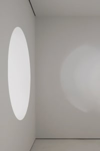 A minimalist design featuring a glass space with a circular window.