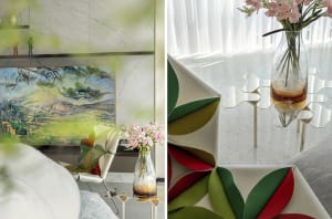 Modern living room featuring a combination of glass, fabric, and marble materials, with abstract wall art and floral arrangem