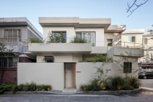 A modern residential house with cement-rendered exterior.