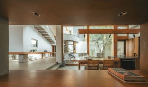 Minimalist interior with wood accents, concrete floor, and glass walls