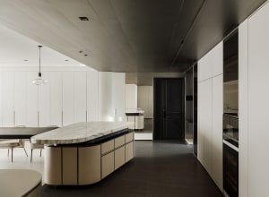 Modern residential kitchen featuring a striking marble countertop and minimalist design elements.