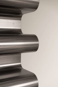 Linear metal staircase with curved steps.