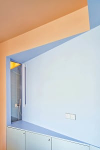 A minimalist interior design featuring glass walls and a geometric layout.