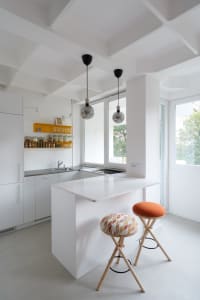 White, minimalist kitchen with a modern design.