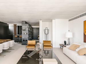 Modern minimalist living room with white walls, wooden floor, and minimalist furniture.