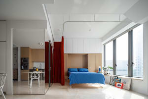 Modern minimalist living room featuring clean lines, wood and glass furniture, and a large window.