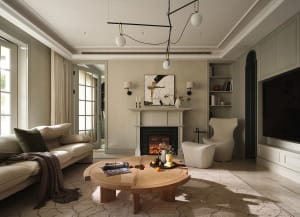 Modern living room featuring a neutral color palette, comfortable seating, a fireplace, and a round coffee table.