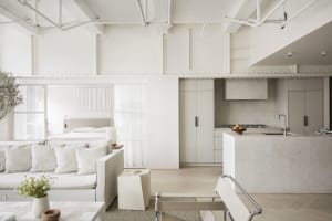 A minimalist living space with all white decor and furniture