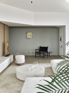 A minimalist living room with marble furniture and white decor.