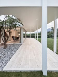 A modern exterior featuring a glass-enclosed jacuzzi.