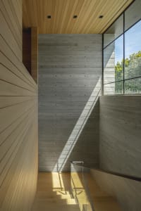 Modern interior design featuring concrete and wooden walls and floors.