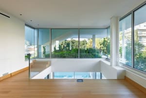 Modern living room featuring glass walls, steel elements, and minimalist design