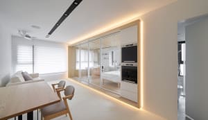 Modern residential living room with white matte upholstery, featuring sleek furniture and minimalistic design.