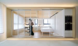 Modern bedroom with transparent glass walls and white furnishings