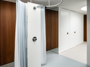 Modern bathroom with white curtain and wood paneling