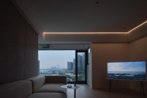 A modern living room with minimalist design featuring wood floors and a city view.