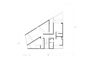 Floor plan of a modern upper level with furnished rooms and architectural details.