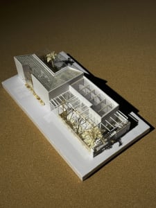 Modern residential greenhouse with glass walls and concrete base
