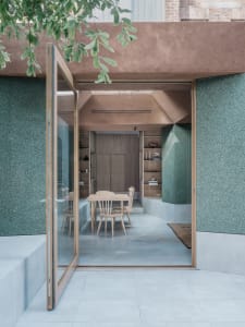 A minimalist dining room with wooden elements.