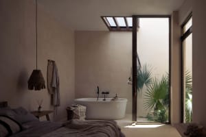 Modern minimalist bathroom featuring a concrete bathtub and a view into an indoor garden.