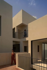 Modern building exterior with concrete walls and black metal railings