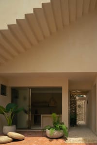 A minimalist interior design featuring concrete walls and a stairs.