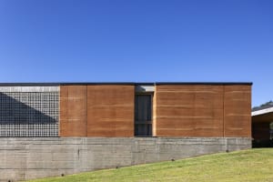 A modern building with a clay exterior and a concrete foundation.