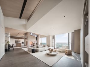A modern living room with concrete flooring and minimalist design.