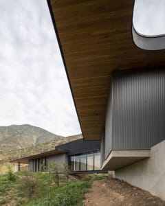 A modern house with a metal exterior and a sloped roof.