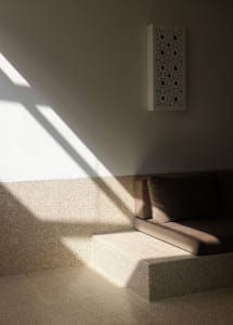 A sunlit corridor featuring tiled flooring and natural light.
