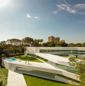 Modern house featuring glass, concrete, and marble exteriors.