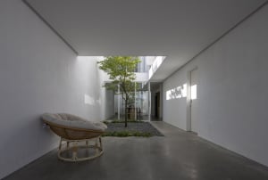 Modern residential interior with glass walls and concrete flooring