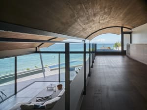 Modern residential space featuring wood, glass, and concrete materials.