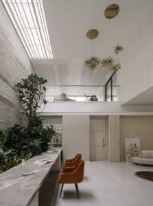 A minimalist living room featuring concrete, marble, and wooden elements.